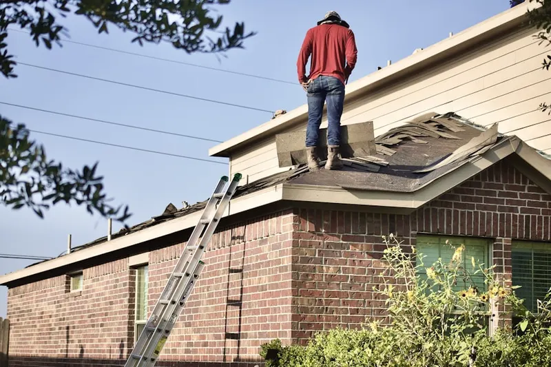 Professional roofer working on a residential roof in Stonerstown
